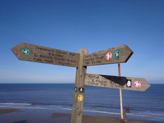 Timber directional sign for the Norfolk Coastal Path.