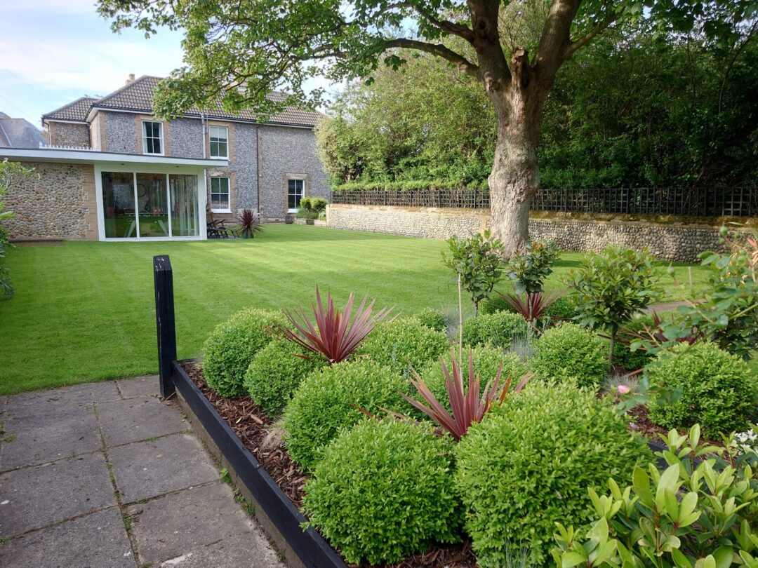 Looking across the gardens to the rear of North Cottage Cromer, featuring the huge 70m square garden room in the foreground.
