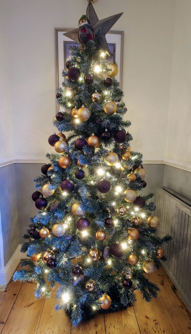 Elegant 6ft6" artificial Christmas tree decorated in Ochre and Gold.