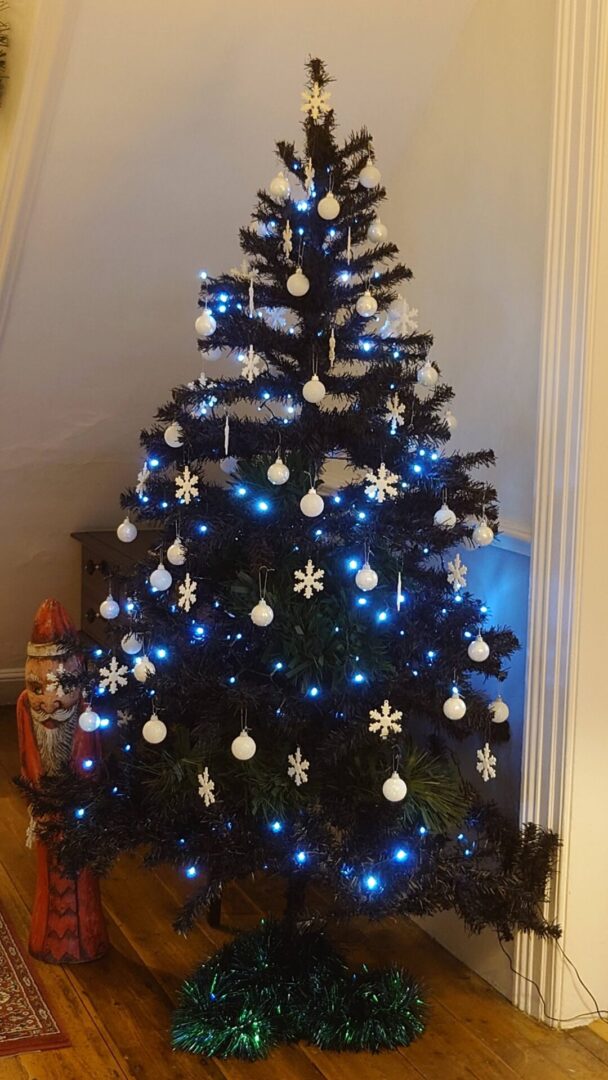 Modern ebony 5ft artificial Christmas tree decorated in black and white.